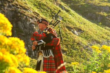 a man in a kilt with a bagpipe in his hands